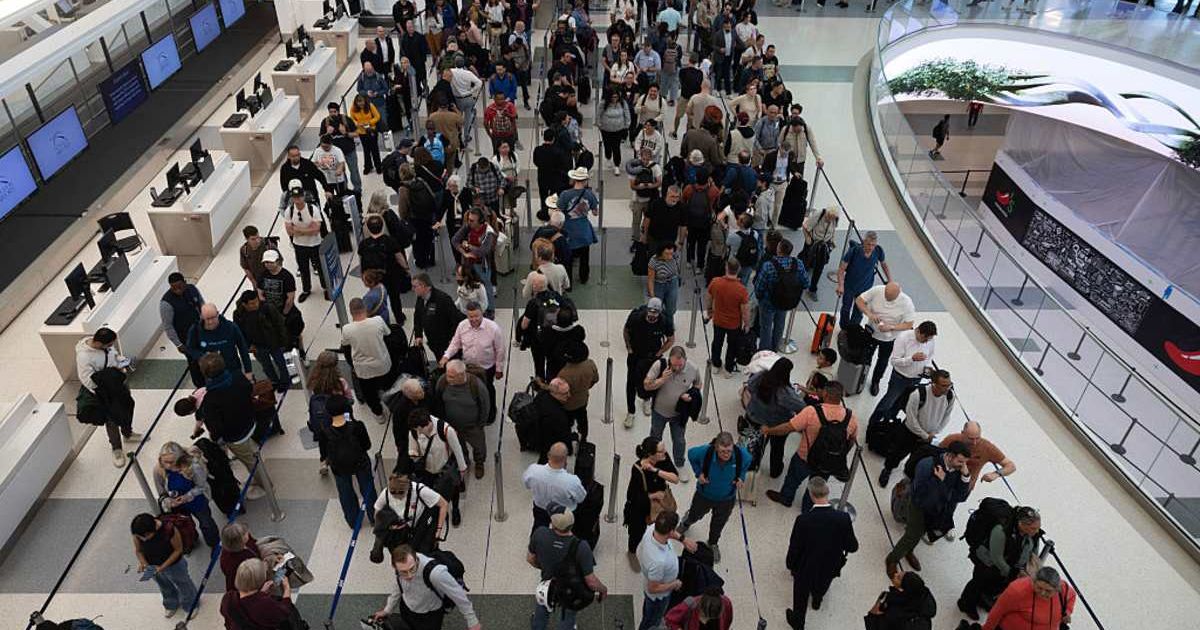 Travelers wait in line at George Bush International Airport on March 19, 2026, amid the federal shutdown affecting the TSA (Cover Image Source: Getty Images | Photo by Antranik Tavitian)