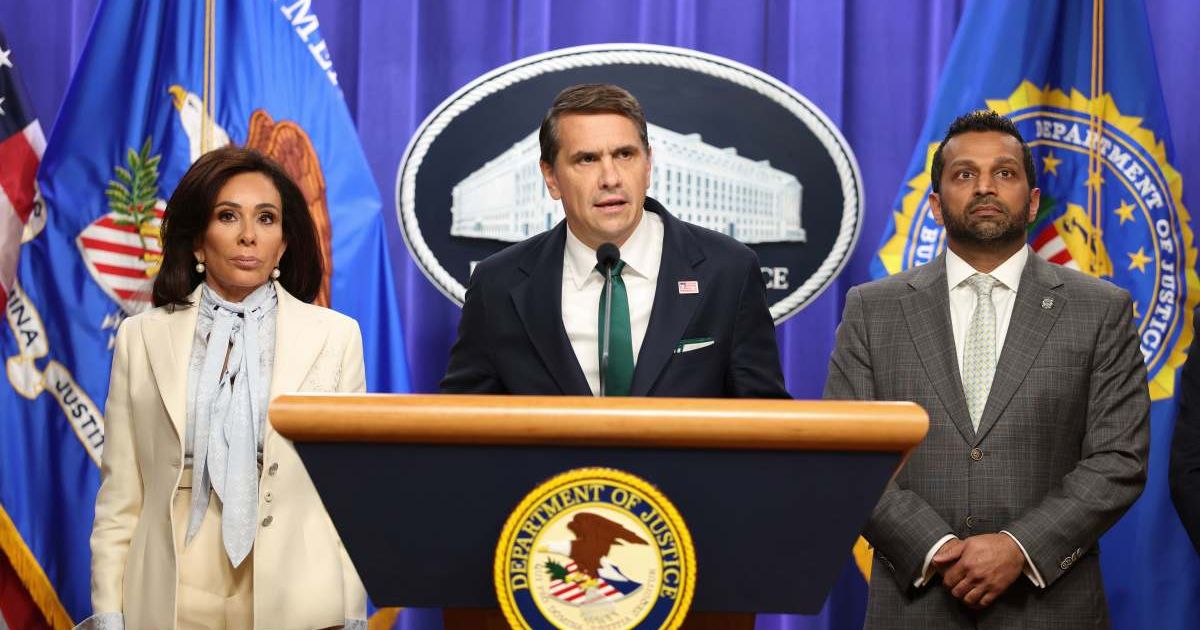 Acting Attorney General Todd Blanche speaks as U.S. Attorney Jeanine Pirro and FBI Director Kash Patel listen, at a press conference at the Department of Justice on April 27, 2026 (Cover Image Source: Getty Images | Photo by Tasos Katopodis)