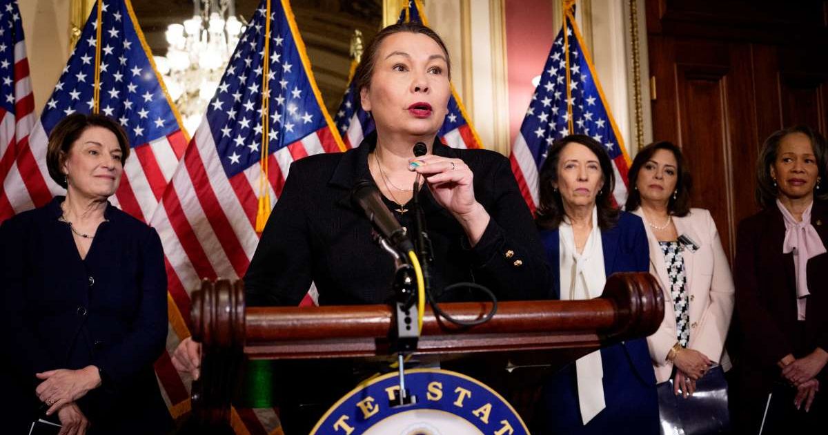 Senator Tammy Duckworth (D-IL) (C) speaks during a news conference at the U.S. Capitol Building (Cover Image Source: Getty Images | Photo by Andrew Harnik)