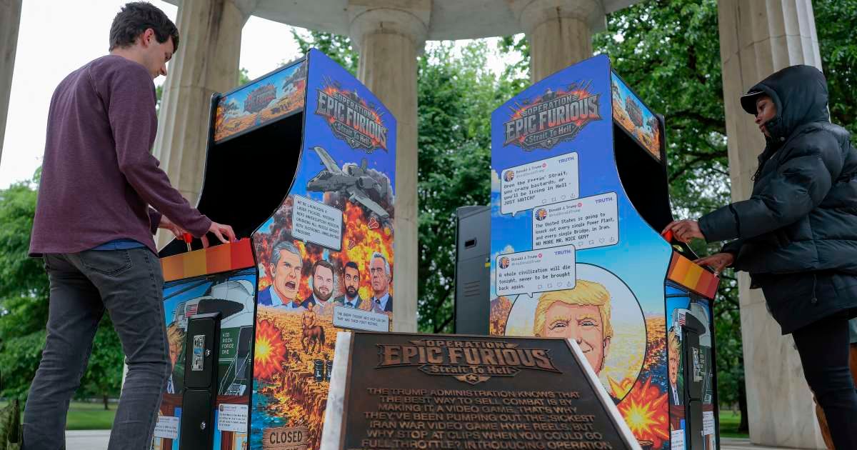 People play a satirical video game installation titled 'Operation Epic Furious Strait to Hell', created by Secret Handshake, at the District of Columbia War Memorial on May 11, 2026 (Cover Image Source: Getty Images | Photo by Heather Diehl)
