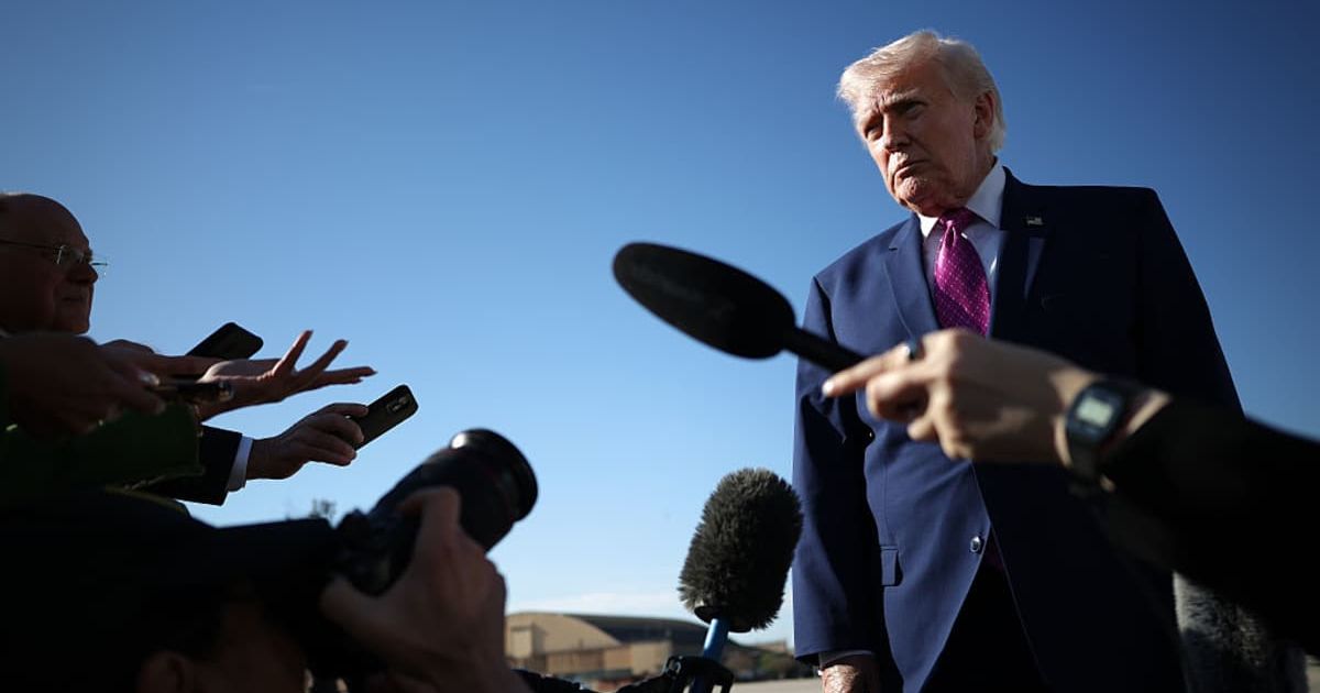 U.S. President Donald Trump speaks to reporters before boarding Air Force One (Image Source: Getty Images | Photo by Win McNamee)