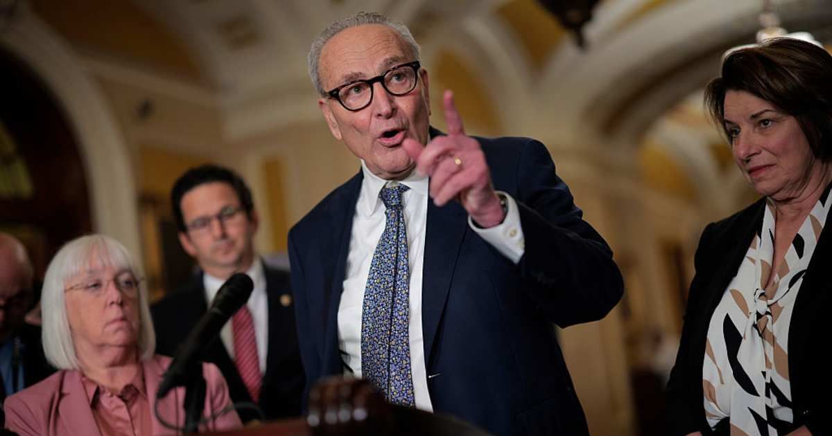 Senate Minority Leader Charles Schumer (D-NY) (C) talks to reporters following the weekly Senate Democratic policy luncheon at the U.S. Capitol (Cover Image Source: Getty Images | Photo by Chip Somodevilla)