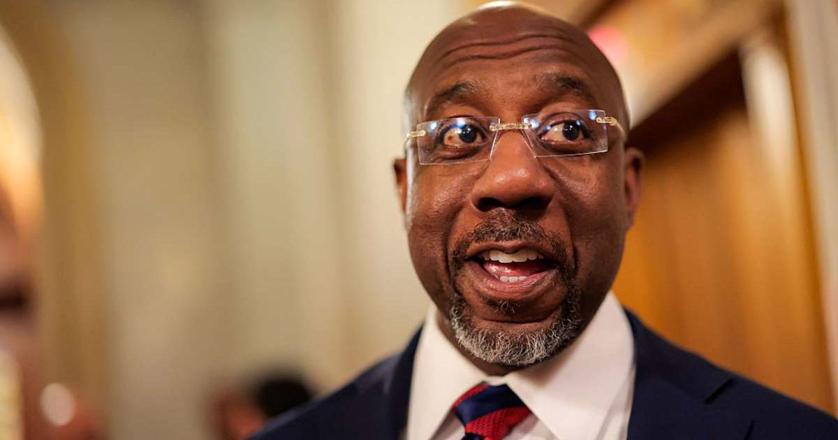 U.S. Sen. Raphael Warnock speaks with reporters on March 23, 2026, in Washington, DC. (Cover Image Source: Getty Images | Photo by Heather Diehl)