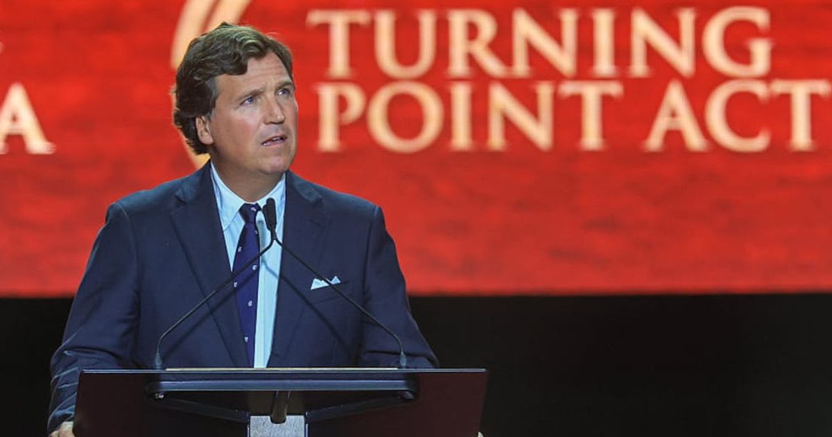 Political commentator Tucker Carlson speaks during the memorial service for political activist Charlie Kirk at State Farm Stadium on September 21, 2025 (Cover Image Source: Getty Images | Photo by Joe Raedle)