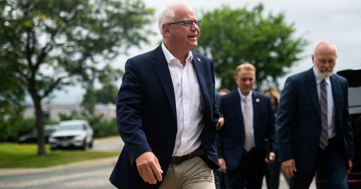 Minnesota Governor Tim Walz arrives to speak at a press conference at City Hall on August 1, 2024 (Cover Image Source: Getty Images | Photo by Stephen Maturen) 