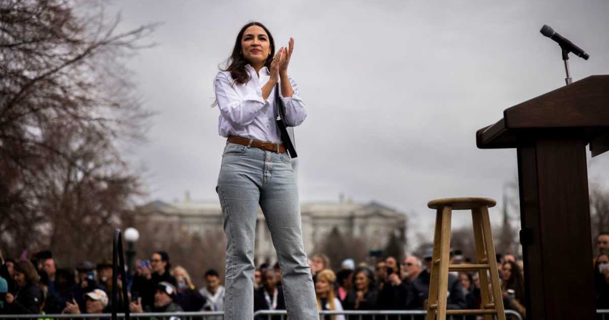 U.S. Rep. Alexandria Ocasio-Cortez (D-NY) welcomes Bernie Sanders onstage during a rally (Cover Image Source: Getty Images | Photo by Chet Strange)